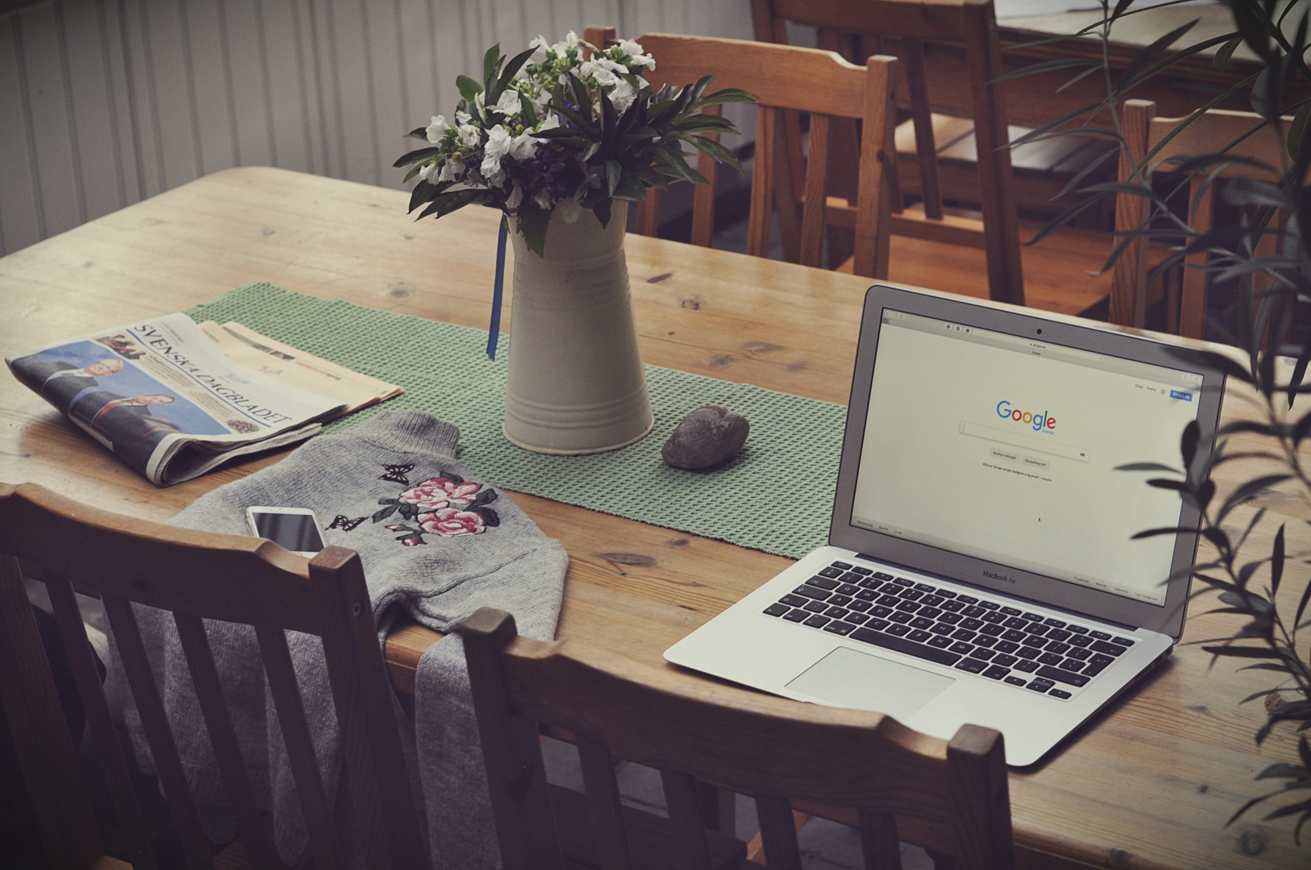 table with laptop and newspaper