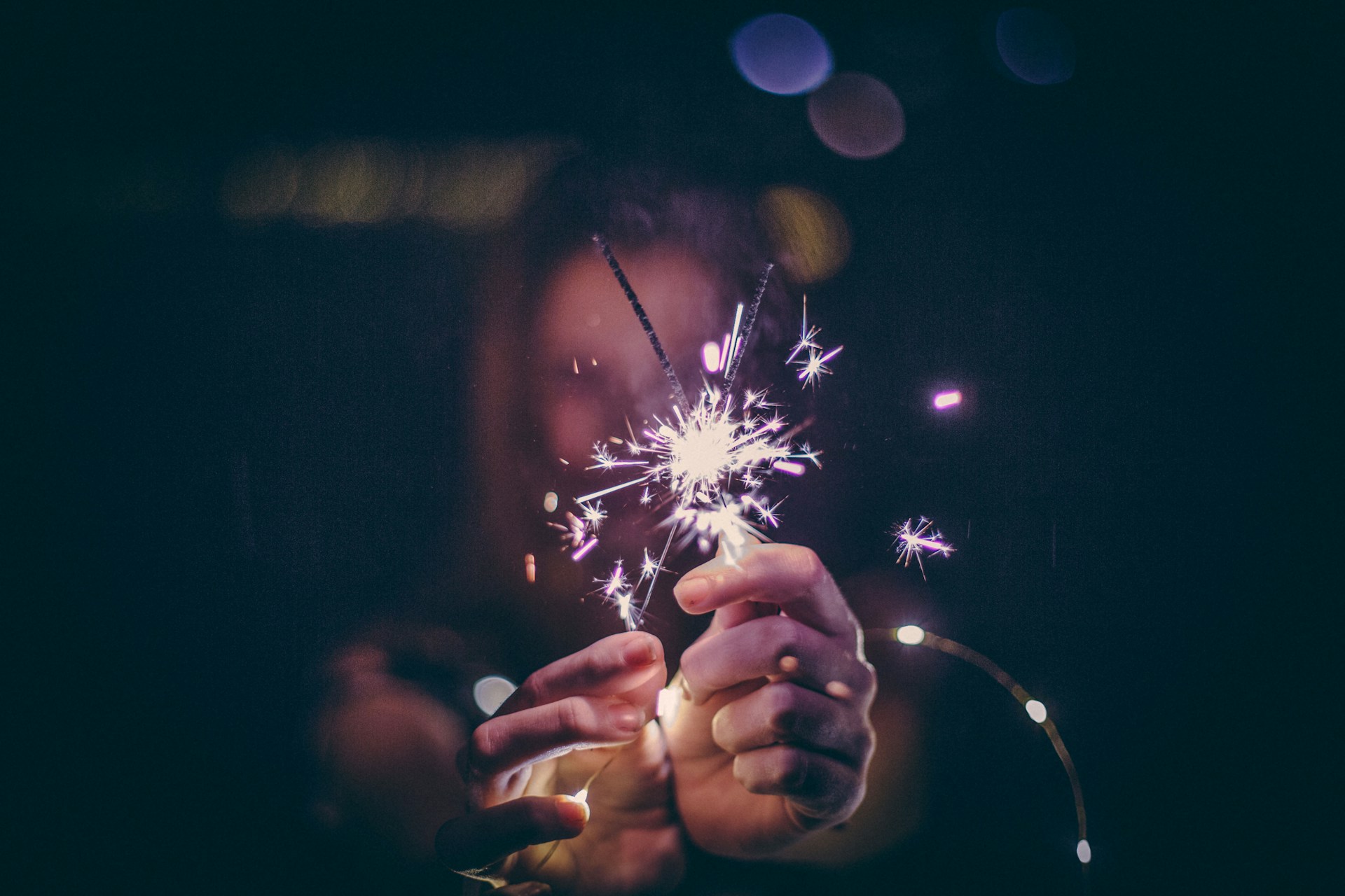 Girl holding sparkler firework