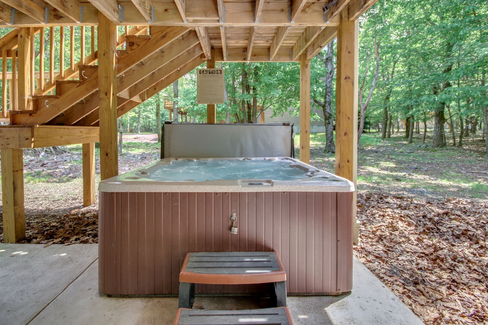 Outdoor hot tub under stairs