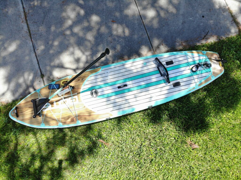 A paddleboard and paddle on the grass